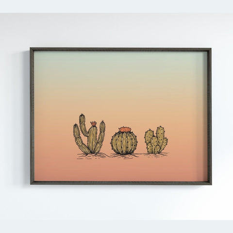 Three Cacti Against a Blue and Orange Sky