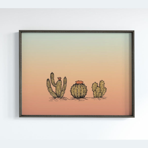 Three Cacti Against a Blue and Orange Sky